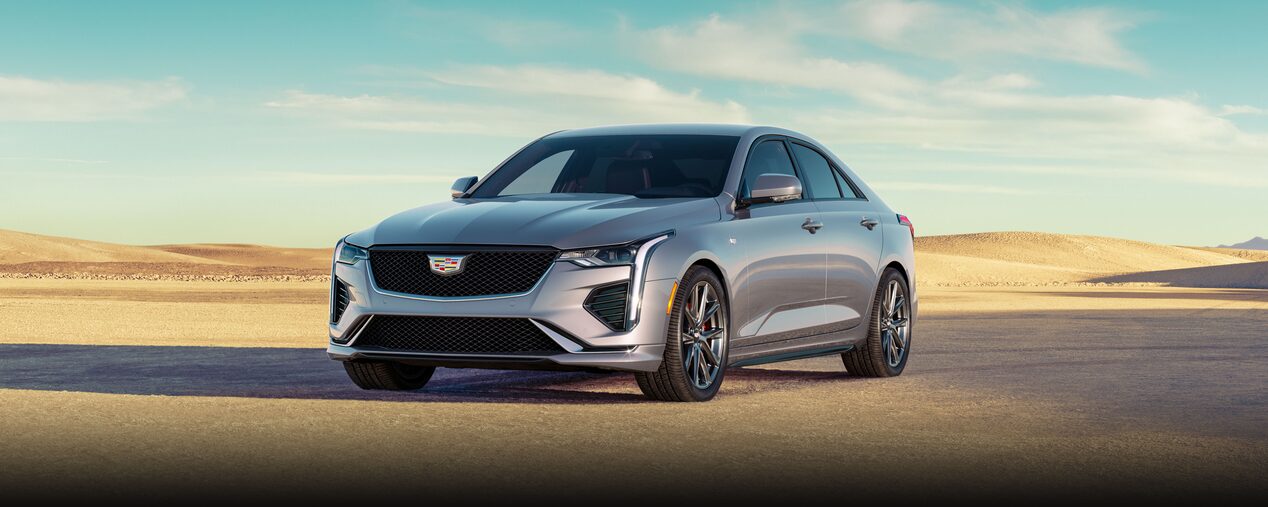 Three Quarters Front View of a Silver 2026 CT4 Parked in the Open Desert