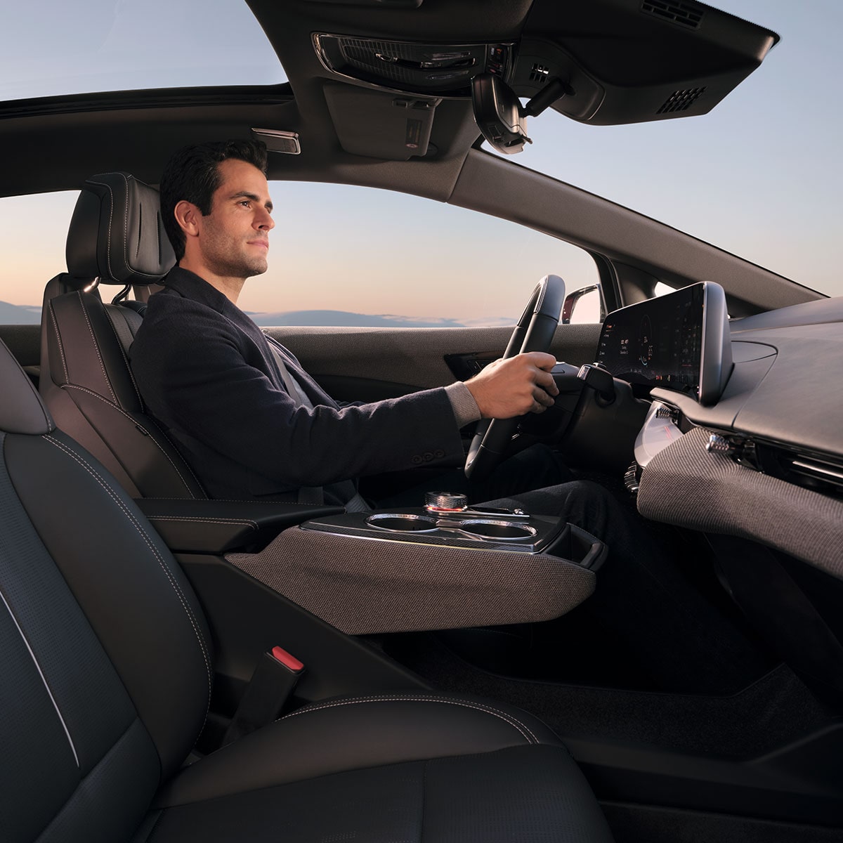 A Man Driving a 2026 Cadillac OPTIQ