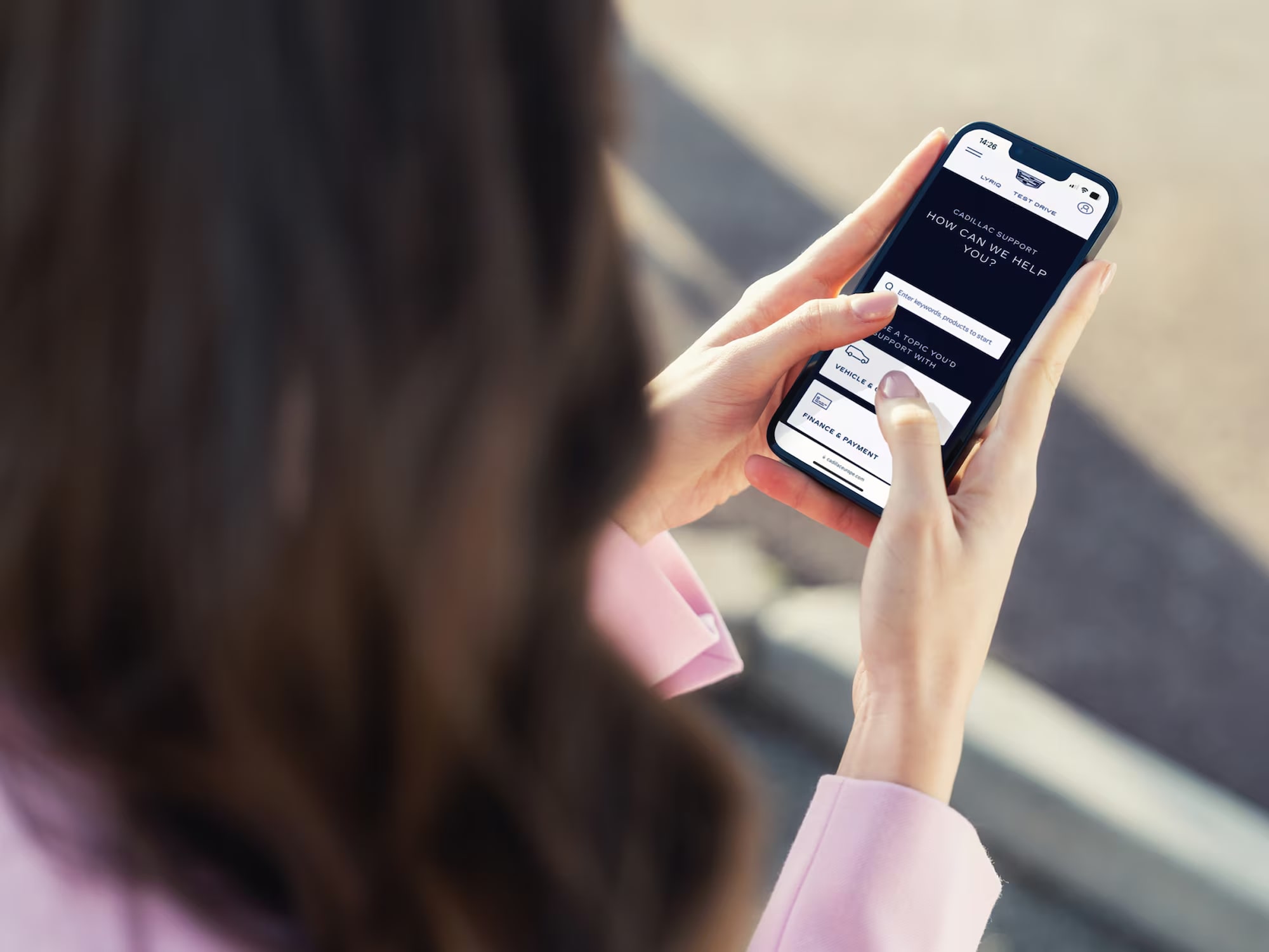 Close up of the Cadillac website on a mobile phone.