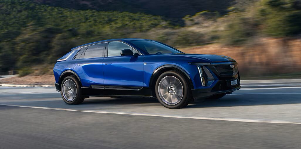 Cadillac LYRIQ driving on a scenic road