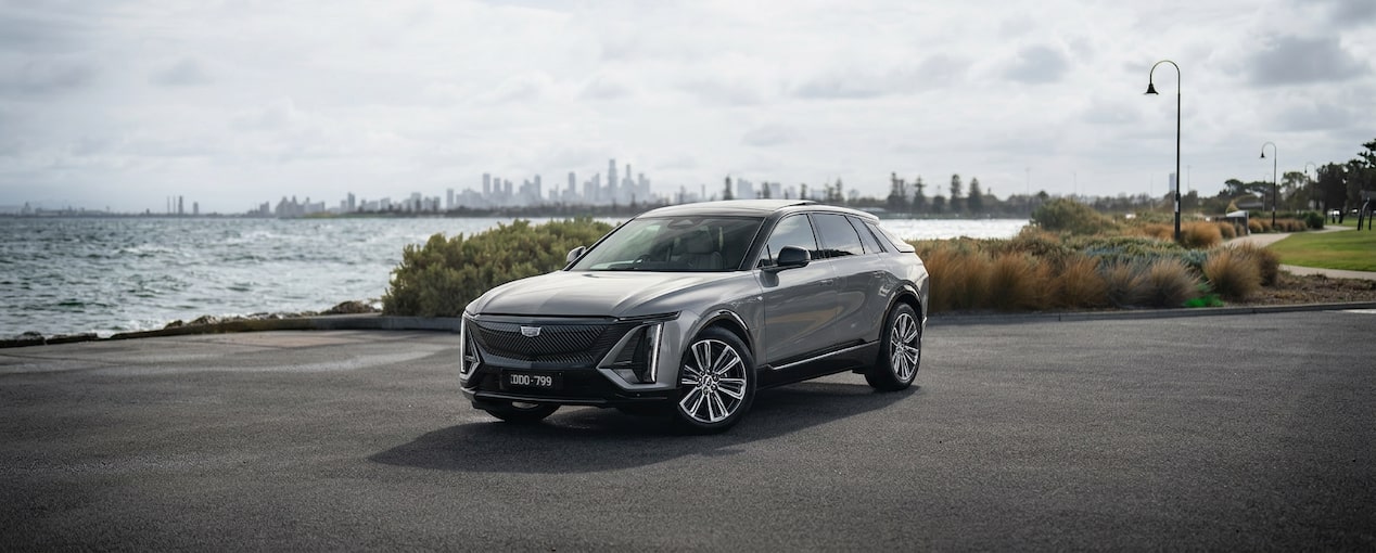 Image of the Cadillac LYRIQ, with a sunset, and click through to test drive, design & price or request a call