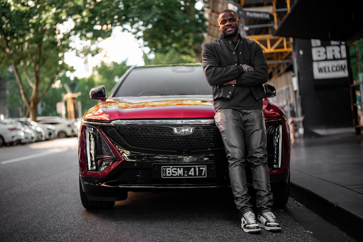 Frances Tiafoe arms crossed with Cadillac Lyriq