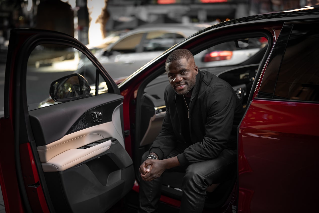 Frances Tiafoe sitting inside Cadillac Lyriq