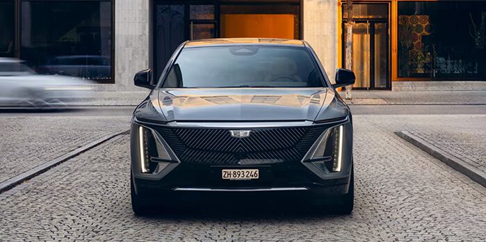 Man on mobile phone with Cadillac LYRIQ